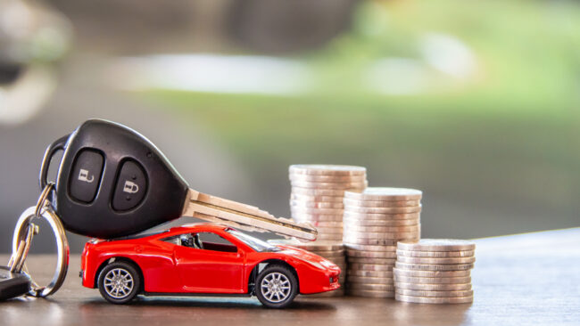 Red,Car,And,Key,On,Stacks,Of,Coin,,Car,Loan